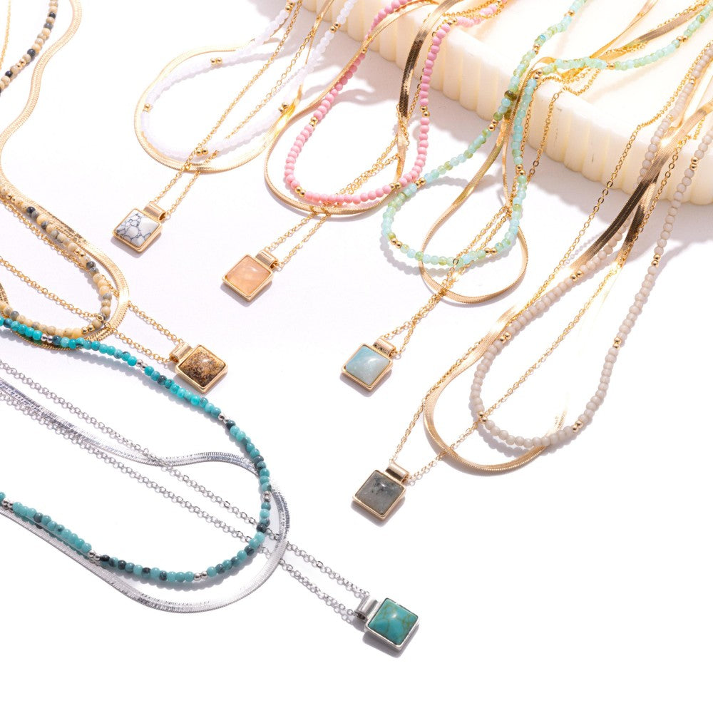 Layered Chain Link Necklace Featuring Metal Tones, Stone Beads, & Square Stone Pendant