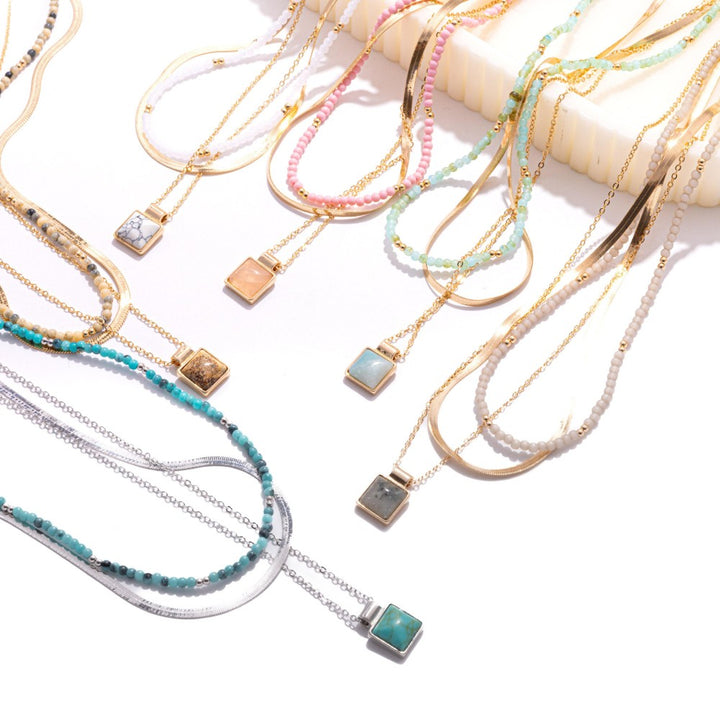 Layered Chain Link Necklace Featuring Metal Tones, Stone Beads, & Square Stone Pendant