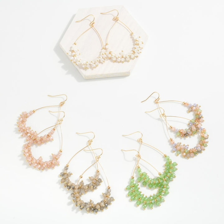Metal Tone Wire Teardrop Earrings Featuring Faceted Bead Details