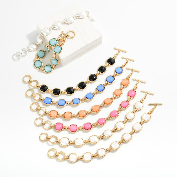 Metal Tone Bracelet Featuring Glitter Resin Squared Stations With Toggle Clasp