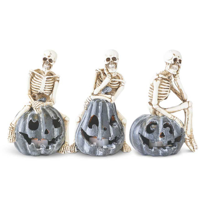 Skeleton Sitting on LED Jack O Lantern