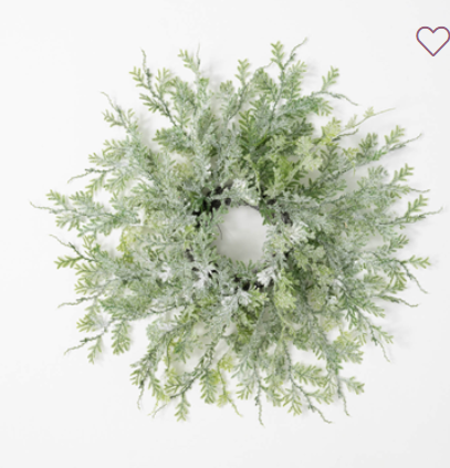 Frosted fern ring 6.5"  This soft to the touch simple greenery is the perfect base for adding decor to, or simply displaying as it is. The dusted snow covering gives the monochromatic branches a little texture and personality.